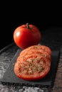 Sliced Ã¢â¬â¹Ã¢â¬â¹and whole tomatoes with herbs Royalty Free Stock Photo